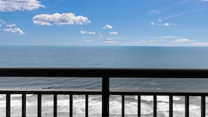 A view of the ocean from a balcony with a railing, clear sky, and some clouds. - Amazing Oceanfront 1 Bedroom Suite 19th Floor (Myrtle Beach)