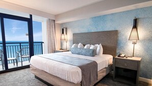 A spacious bedroom with a large bed, a nightstand, and a view of the ocean through a balcony. - Your Oceanfront Oasis 21st Floor 3 Bedroom Deluxe (Myrtle Beach)