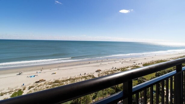 A beach view from a balcony with a railing, sandy beach, and ocean. - Your Oceanfront Oasis 9th Floor 3 Bedroom Deluxe (Myrtle Beach)