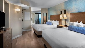 A hotel room with two beds, a TV, a dresser, and a view of the outdoors. - Seaside Luxury: 10th Floor Ocean View Studio (Myrtle Beach)