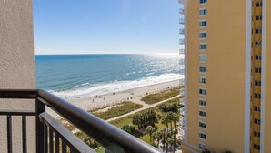 A high-rise building with a balcony overlooking a beach. - Seaside Luxury: 10th Floor Ocean View Studio (Myrtle Beach)