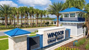 A sign for Windsor Island Resort with a blue roof and a stone base. - 6BR Villa w/Theater & Pool near Disney (Davenport)