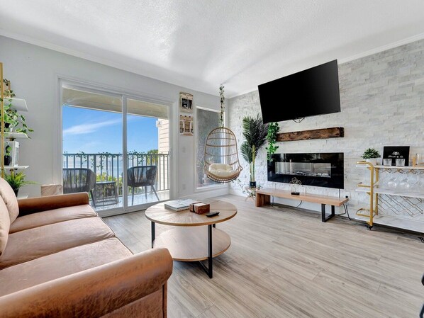 Sink into the plush sofa and let your eyes drift across the chic fireplace and modern décor. Slide open the balcony doors to feel the breeze and soak in your peaceful surroundings.
