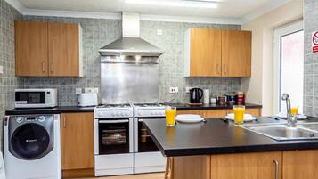 Full-sized fridge, microwave, stovetop, cookware/dishes/utensils