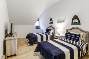 A bedroom with two beds, a television, a lamp, and decorative wall art. - 2 Mi to Bethany Beach! Family Home w/ Deck (Frankford)