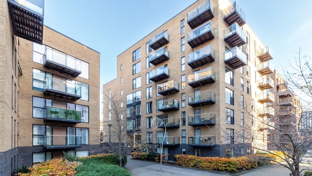A modern apartment building with multiple balconies and large windows. - The Lewisham Collection (London)