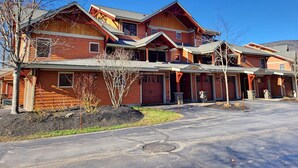 A large, multi-story wooden house with a prominent porch and a garage. - Open plan, AC/FP, pool access, at South Peak, ski shuttle. P002F by LRS (Lincoln)