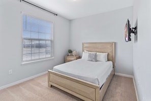 Queen's Quarters: Bedroom 1 welcomes with a cozy queen size bed, promising restful nights and rejuvenating mornings in a tranquil retreat - 5BR Townhouse w/ Private Pool & Mickey-themed Room (Davenport)