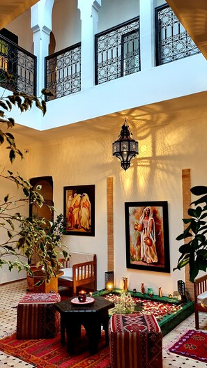 A spacious courtyard with a high ceiling, ornate iron railings, and a hanging lantern. - Dar Salam Palm (Marrakech)