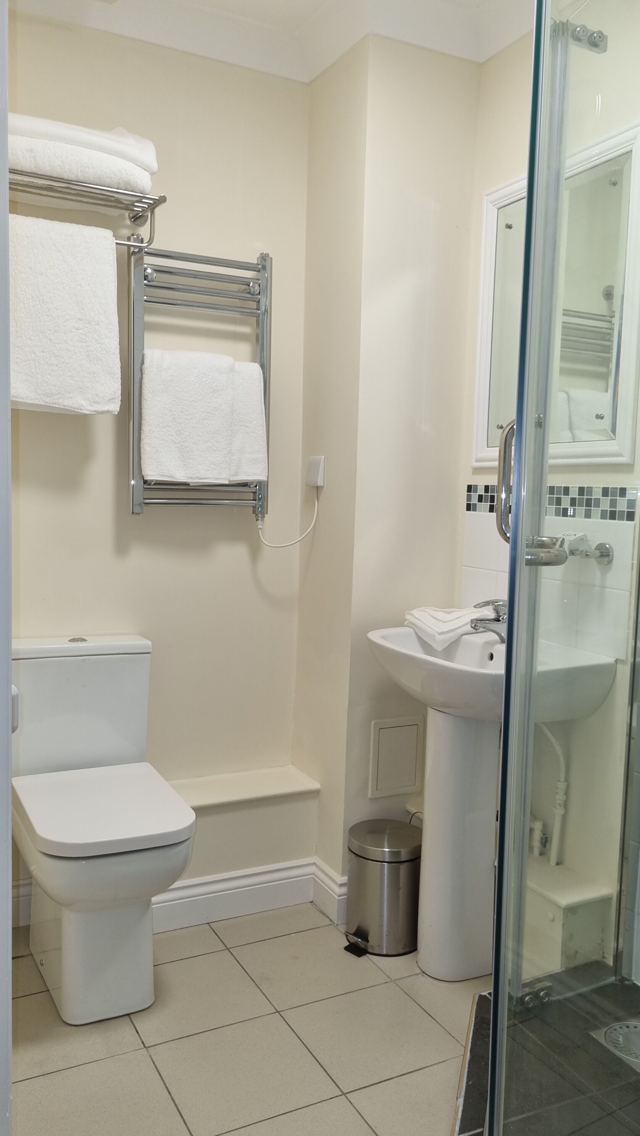 Une salle de bain avec des toilettes, une douche et un lavabo.