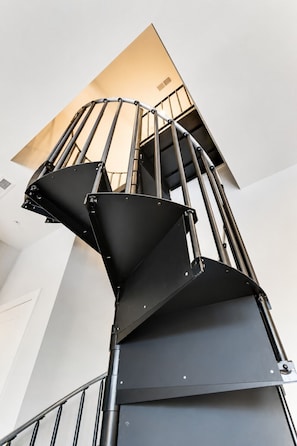 A spiral staircase with metal railings and a black handrail. - West End 4 Bd/4Bath Walk to Bars-Close to Broadway (Nashville)