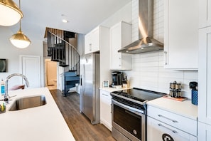 A modern kitchen with stainless steel appliances, a built-in oven, and a central island. - West End 4 Bd/4Bath Walk to Bars-Close to Broadway (Nashville)