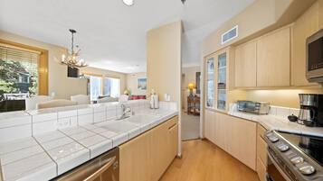 A modern kitchen with a dishwasher, stove, and microwave.