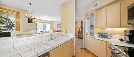 A modern kitchen with a dishwasher, stove, and microwave.