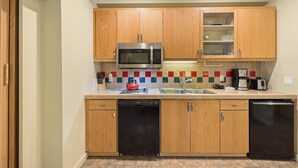 A compact kitchen with wooden cabinets, a microwave, a dishwasher, and a coffee maker. - 250 | Easy-Breezy Studio -AC, Spas, Pool & Tennis (Olympic Valley)
