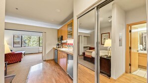 A modern hotel room with a kitchen area, a dining area, and a large sliding glass door leading to a balcony. - 246 | Scenic Studio - Hit Trails, Then Hot Tubs (Olympic Valley)