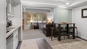 A compact living space with a kitchen, dining area, and seating area. - 227 | Studio Retreat - Hike & Golf Your Days Away (Olympic Valley)
