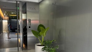 An elevator with a number plate, a glass door entrance, and potted plants. - Apartment in Palermo Hollywood, Buenos Aires, Argentina (Buenos Aires)