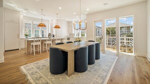 A spacious kitchen with a large island, white cabinetry, and a view of the outside. - "62 Blue View" Lakefront Private Pool Short Walk to the Beach (Santa Rosa Beach)