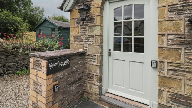 A stone building with a white door and a sign reading "Upper Vestibry." - Upper Vestry (Llandysul)