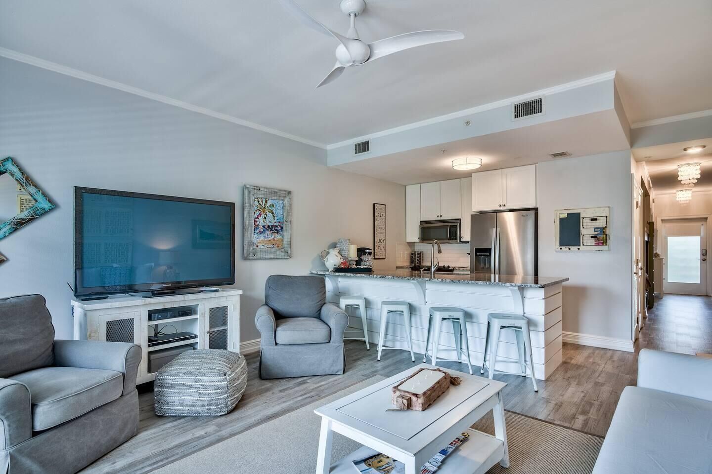 A modern apartment with a living room, kitchen, and dining area.