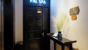 A black door with a sign reading "PAL SPA" and a plaque with room numbers. - Palago Boutique Hotel (Hanoi)