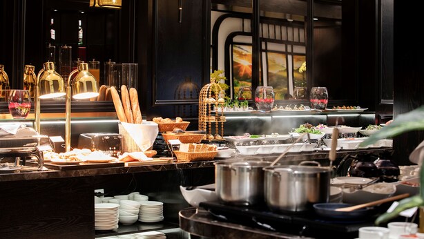 A buffet setup with various food items and dishes. - Palago Boutique Hotel (Hanoi)