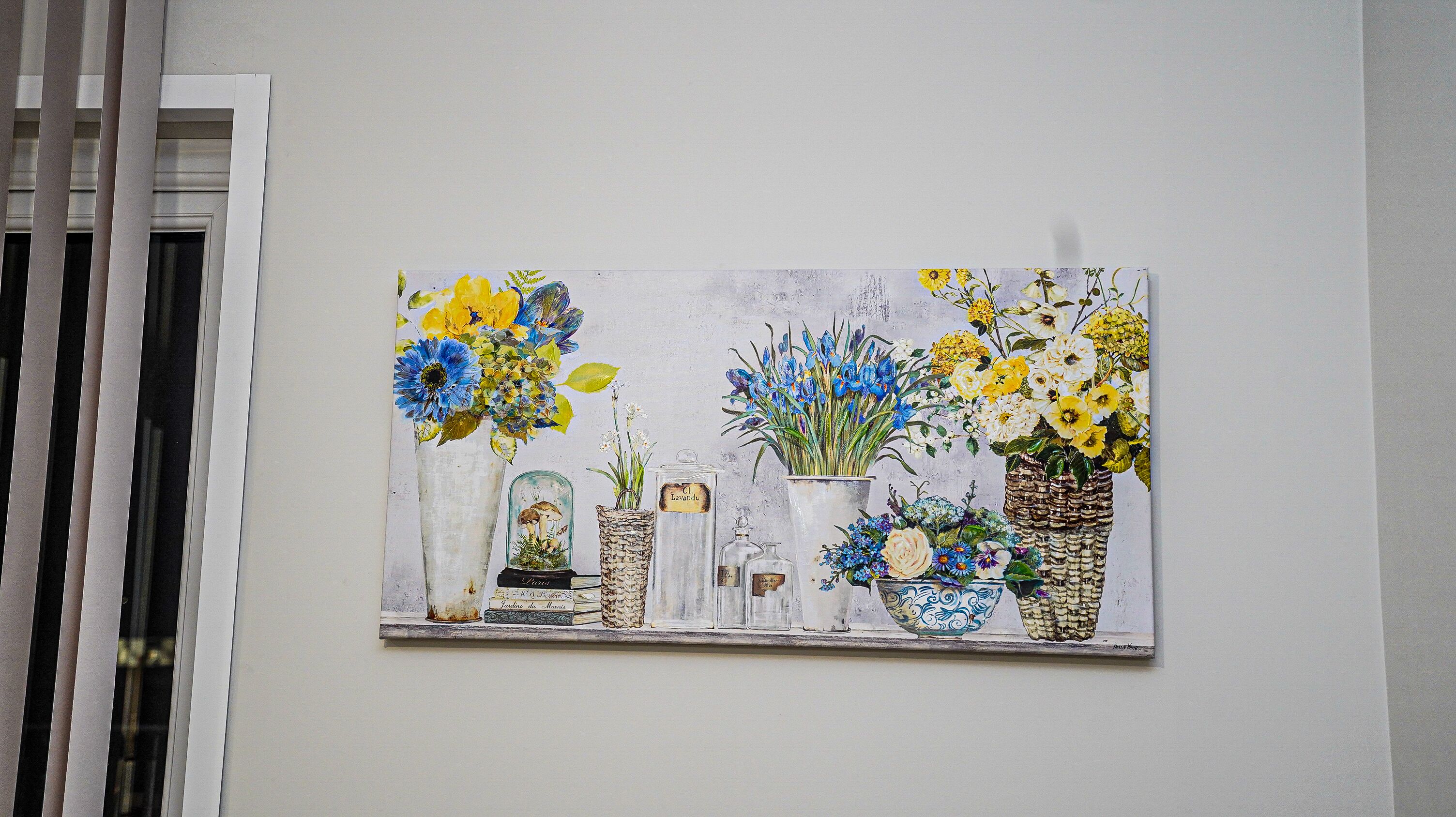 A painting of various flowers in vases and containers on a wall.