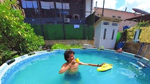 Una persona en una piscina con un flotador amarillo.
