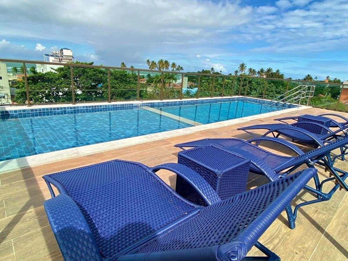 A poolside area with blue lounge chairs and a clear view of the pool.