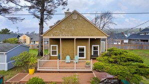 A two-story house with a porch, a small deck, and a well-maintained garden. - Treasure Paradise MCA#522-Only 1 1/2 blocks to the beach. Close to everything (Manzanita)