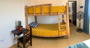 Cozy retreat with a bunk bed, desk, and potted cactus.