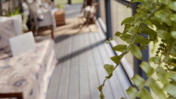A covered porch with seating, hanging plants, and string lights. - Creekside Cottage Near Nashville- Pet Friendly! (Pegram)