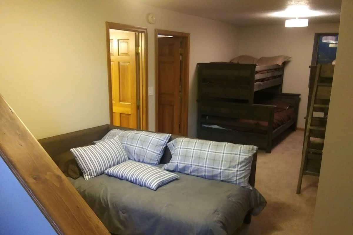 A bedroom with a bed, a dresser, and a wardrobe.