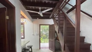 A hallway with patterned flooring, a staircase, and a ceiling fan. - El Caracol Azul #2, Punta Uva Beach (Punta Uva)