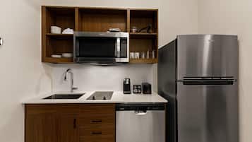 Full-size fridge, microwave, cookware/dishes/utensils, paper towels
