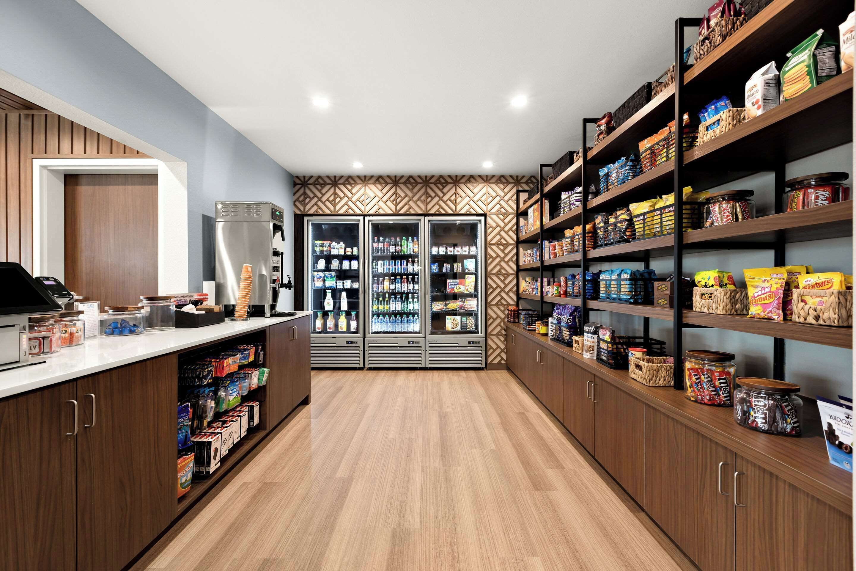 A well-organized pantry area with shelves stocked with snacks, beverages, and condiments.