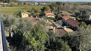 A residential area with houses, trees, and a clear sky.