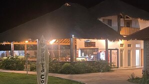 A building with a sign reading "El Palmar" and a signpost with "SantaCoco" visible. - PUNTA COCO VILLAS BEACH (Cojimies)