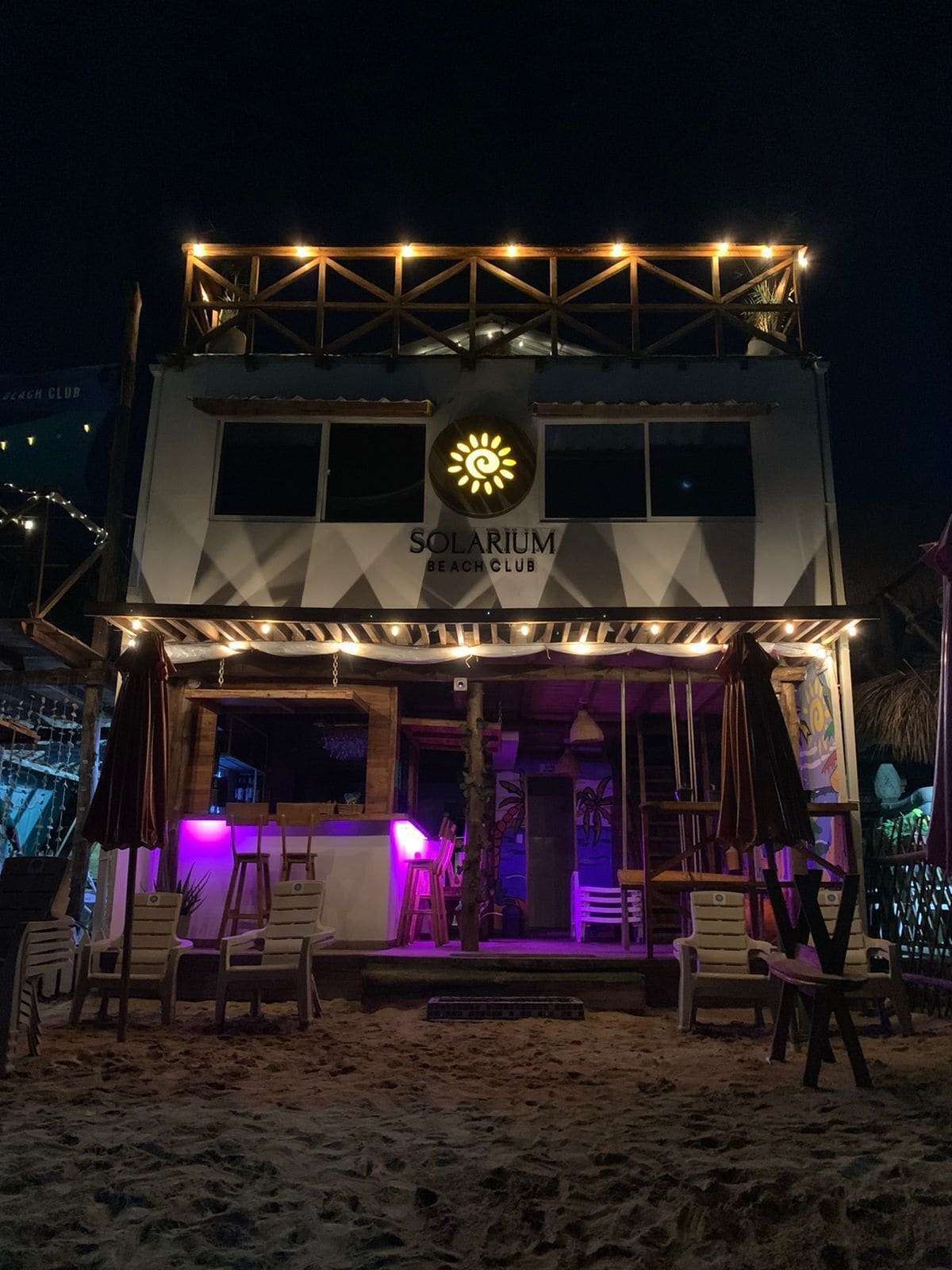 A two-story building with a sign reading "SOLARIUM BEACH CLUB".
