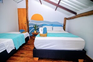 A room with two beds, a wooden floor, a wall mural, and a small table with a plant. - Solarium Beach Club (Cartagena)
