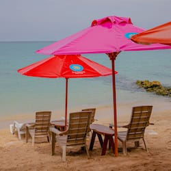 On the beach, white sand, sun-loungers, beach umbrellas