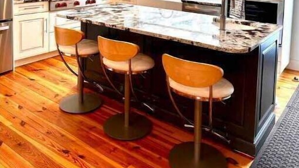 A modern kitchen with a large island, bar stools, stainless steel appliances, and a window above the sink. - Chef's Kitchen + Minutes to Boyne Mountain + Walk Downtown (Boyne City)