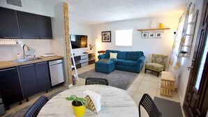 A compact living space with a kitchen, dining area, and seating area. - Beach Getaway - Upstairs
 (St. Augustine)