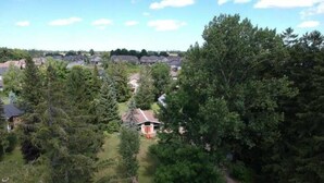 A residential area with houses surrounded by dense trees. - Country Oasis in the Village (Elora)