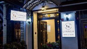 The entrance to Linnga Hotel & Suite with a red carpet, outdoor seating, and illuminated signage. - LINNGA HOTEL & SUITE (Istanbul)