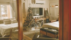 A cozy bedroom with a Christmas tree, a TV, and a desk with a chair. - Pet friendly 2bed 2bath sleeps 6 Cabin in Kings Beach (Kings Beach)