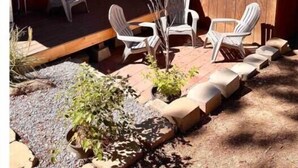 A wooden cabin with a porch, outdoor seating, and a small garden area. - Pet friendly 2bed 2bath sleeps 6 Cabin in Kings Beach (Kings Beach)