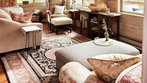 A cozy living room with a fireplace, a sofa set, a coffee table, and a television. - Cozy Cabin with Private Hot Tub and Stunning Views (Silverthorne)