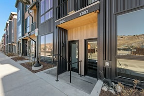 A modern building with large windows and a wooden facade. - 4th Street Crossing #320d By Summit County Mountain Retreats (Silverthorne)
